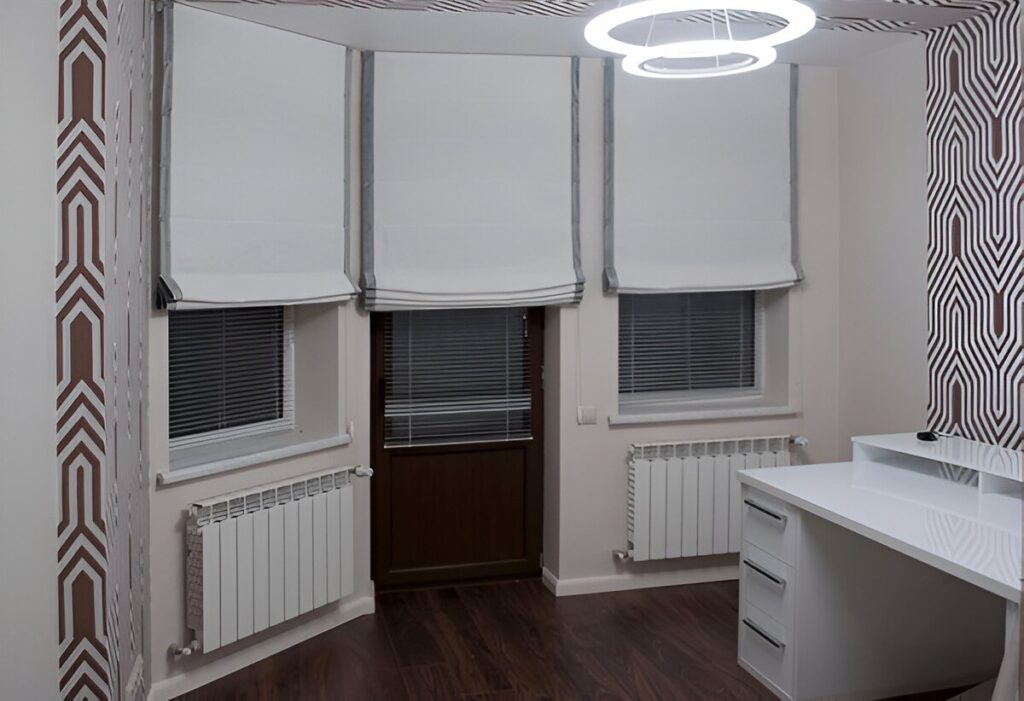 A modern interior featuring light-colored Roman blinds that enhance the decor while offering privacy and style.