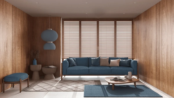 A modern living room with wooden Venetian blinds, blue furniture, and a cozy aesthetic, showcasing how Venetian blinds enhance any space with elegance and functionality.