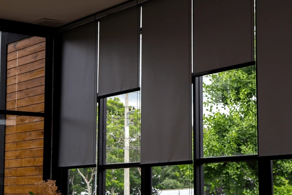 Stylish gray blackout blinds covering large glass windows, providing privacy and modern aesthetics for Dubai homes in 2025.