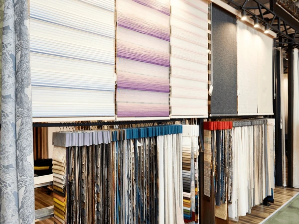 A premium Emirati blinds and curtains shop in Dubai, displaying a wide range of stylish and high-quality window coverings, including Roman blinds, roller blinds, and luxurious drapes.
