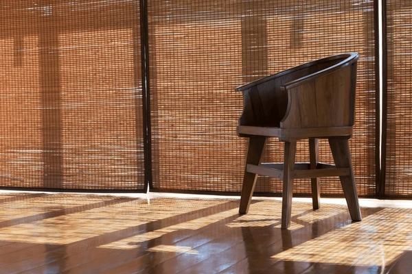 Sunlight filtering through eco-friendly bamboo window blinds, creating a warm ambiance in a modern Dubai interior with recyclable and sustainable materials.