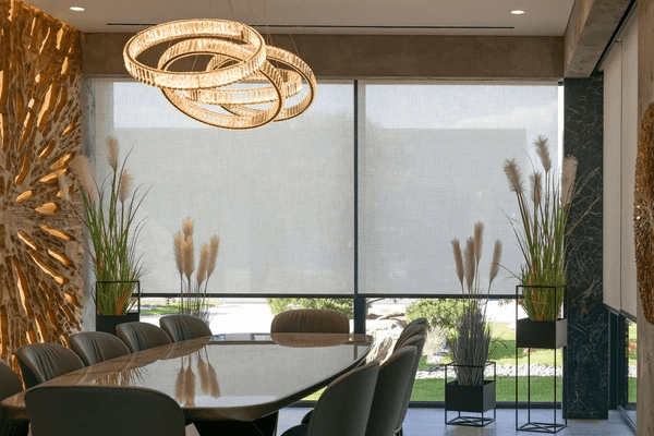 A high-end dining room with floor-to-ceiling soundproof roller blinds, elegant lighting, and modern décor, offering a stylish yet noise-reducing atmosphere.