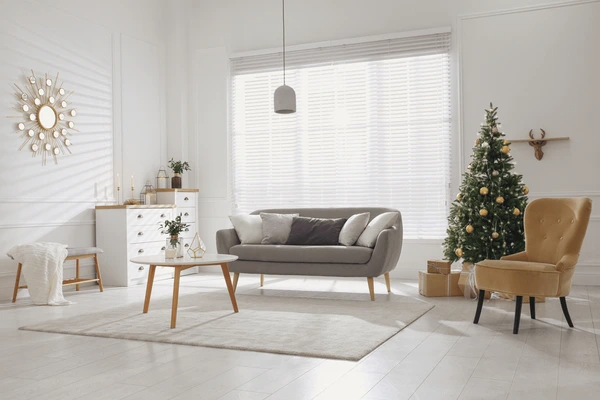 A modern living room featuring elegant white Venetian blinds, designed to keep the cold out and retain warmth, perfect for Dubai winters in 2025.