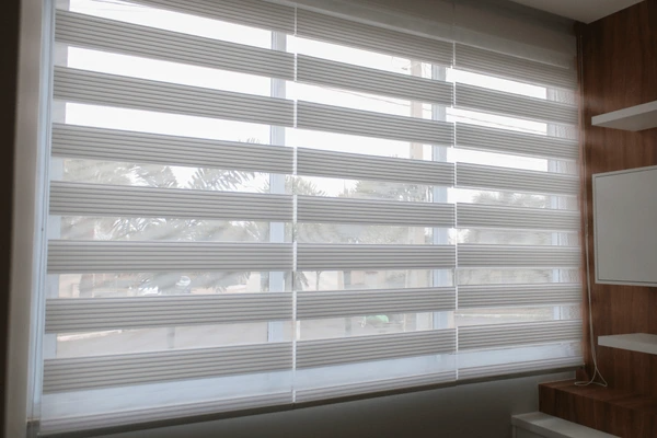 Modern zebra blinds with alternating sheer and opaque layers, providing stylish light control in a contemporary space.