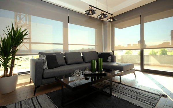 Sleek roller blinds filtering sunlight in a modern Dubai apartment with stylish decor and cozy ambiance.