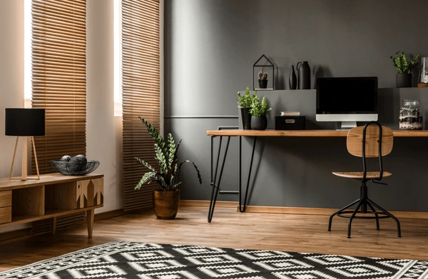 A stylish home office with wooden blinds, a sleek desk setup, and elegant decor in Dubai.