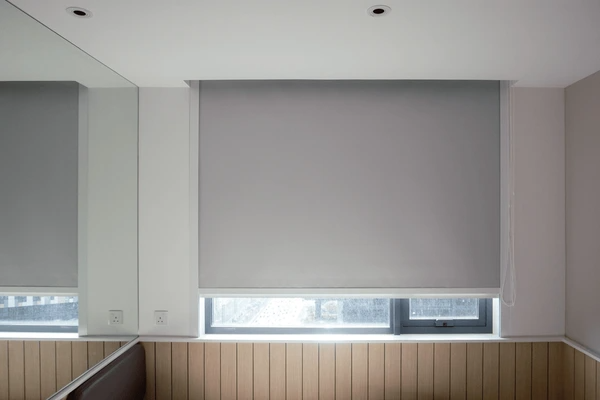 Best Long Blinds in Dubai 2025 - Close-up of sleek gray roller blinds on a large window, blending luxury with modern design.