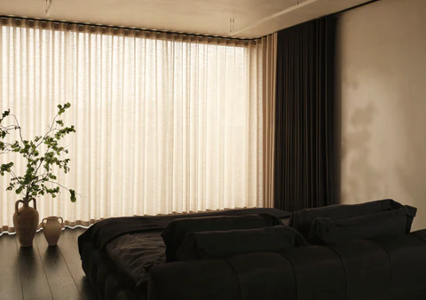 Elegant wave curtains framing a modern bedroom window, creating a sleek and stylish atmosphere in a cozy Dubai home for 2025.
