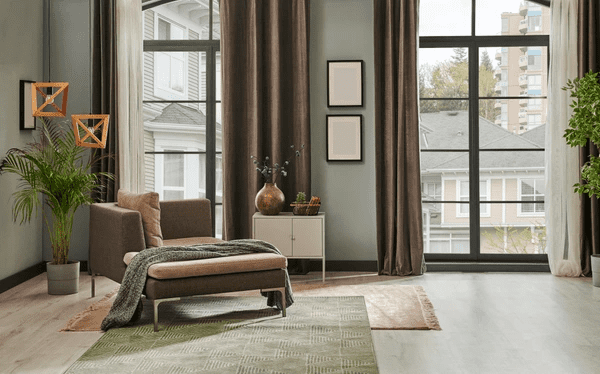  Charcoal grey velvet curtains in a modern living room with large glass windows and cozy furnishings.