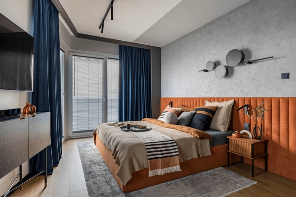 Best Drop Curtains in Dubai 2025 - Elegant dark blue drop curtains enhancing a modern, luxurious bedroom with stylish furniture and decor.