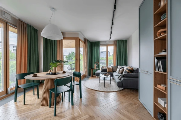 Best Drop Curtains in Dubai 2025 - Luxurious, modern drop curtains in green and orange, complementing a stylish living and dining area with natural light.