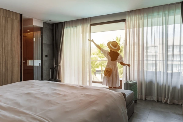 Hotel room with heat-resistant curtains, showcasing luxurious fabric options that provide both comfort and style.
