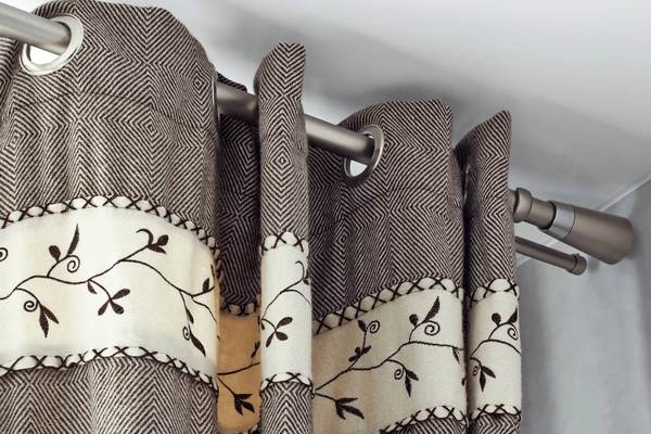 Close-up of soundproof curtains featuring luxurious fabrics with intricate patterns, perfect for cozy and stylish homes.