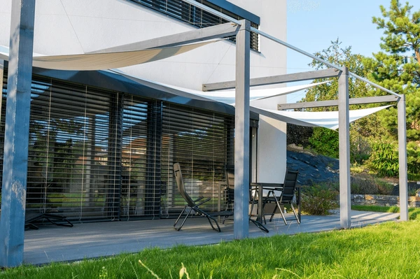 Stylish furnished rental home in Dubai with sleek outdoor blinds, elegant patio furniture, and modern architecture.