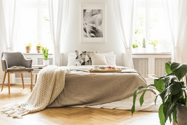 A modern bedroom with high-tech sheer curtains that enhance the space with natural light and privacy, ideal for Dubai homes in 2025.
