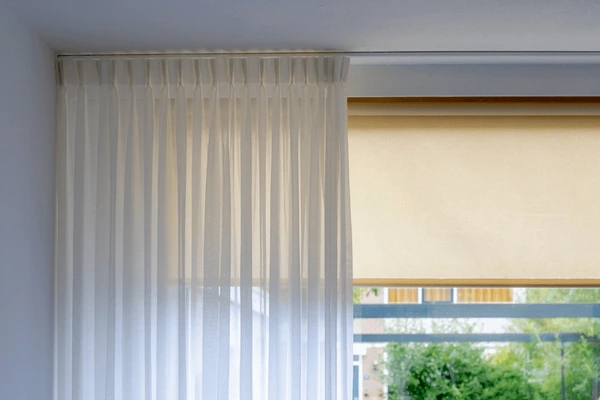 Elegant sheer curtains gently filtering light in a modern room, providing a sleek and cozy atmosphere, ideal for Dubai homes in 2025.