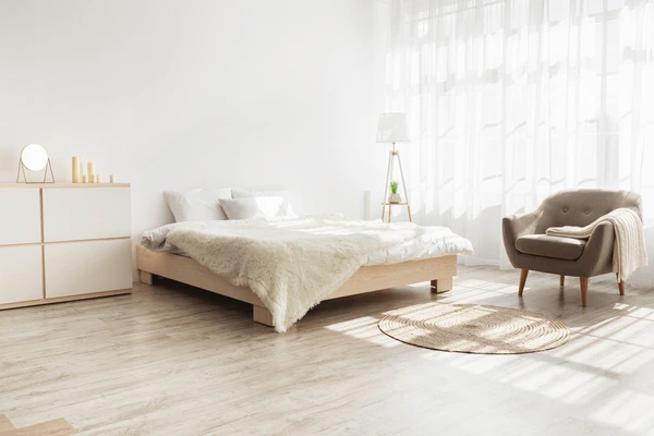 A minimalist bedroom with soft, airy shrink-proof curtains that enhance the serene, light-filled space, creating a cozy and elegant atmosphere.
