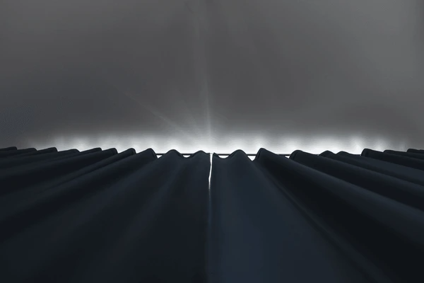 Close-up view of dark blackout curtains fully drawn with minimal light seeping from above, creating a perfect sleep environment.