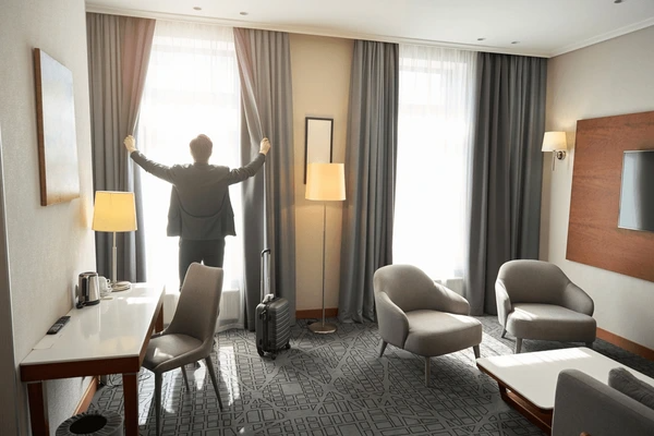 Modern hotel room with soundproof blackout curtains, creating a cozy and stylish atmosphere.