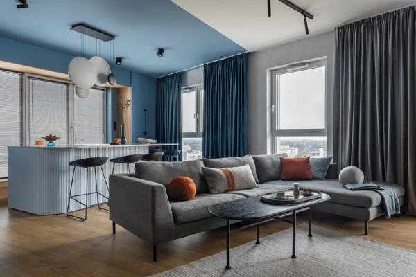 Luxurious living room with soundproof curtains in deep blue, blending elegance with superior noise control.