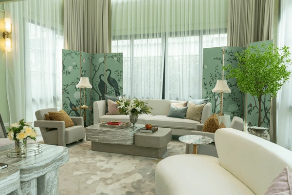 Opulent living room with unwrinkled sheer and blackout curtains, botanical-themed decor, and plush seating in soothing green tones.