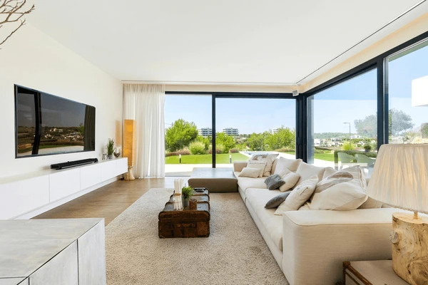Best Washable & Shrink-Proof Curtains in Dubai 2025 for a luxurious and sleek living room, featuring large windows with a modern view.