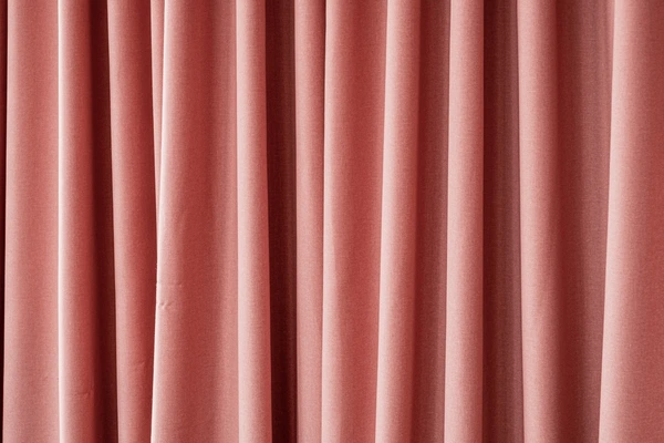 Elegant wave curtains in soft pink, adding a sleek modern touch to the room, ideal for enhancing Dubai homes in 2025.