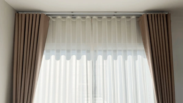 Elegant sheer curtains with a beige border, offering a sleek and bright ambiance, ideal for modern Dubai homes in 2025.