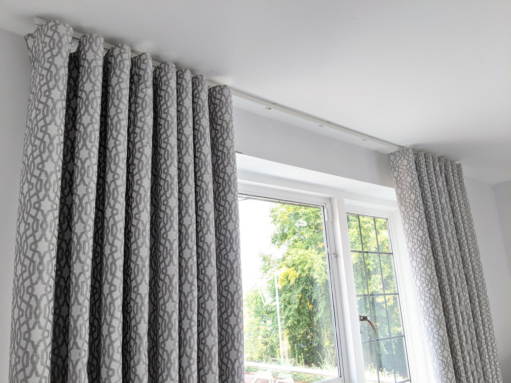 Modern wave curtains in a stylish living room, providing an elegant and sleek touch, ideal for enhancing Dubai homes in 2025.