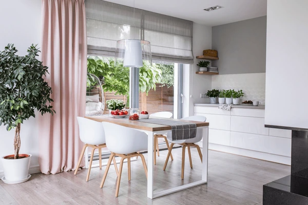 Best Washable & Shrink-Proof Curtains in Dubai 2025 enhancing a bright dining room with soft pink and gray curtains, creating a sophisticated ambiance.
