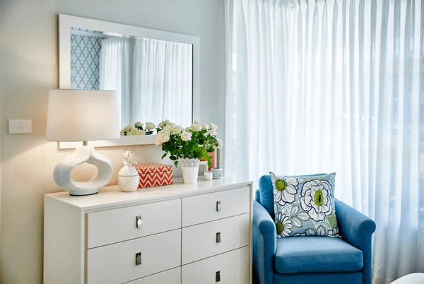 A chic, cozy bedroom with elegant sheer curtains, creating a sleek and airy atmosphere for modern Dubai homes in 2025.
