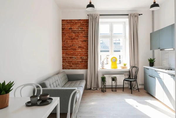 Best Washable & Shrink-Proof Curtains in Dubai 2025 adding elegance to an industrial-style loft apartment with light curtains and modern décor.