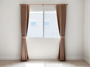 Bronze-colored expensive curtains in a minimalist white room with sunlight streaming through the window.