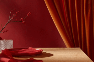 Elegant red and gold velvet curtains with a luxury dining setup in a Dubai home