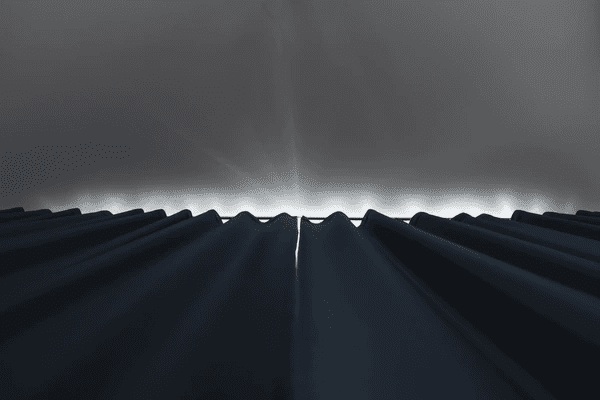 Dark blackout curtains drawn shut in a modern Dubai bedroom, blocking all external light for ultimate sleep comfort.