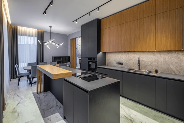 Modern luxury kitchen interior in Dubai with floor-to-ceiling privacy curtains, sleek black finishes, and ambient lighting creating a cozy and elegant atmosphere.