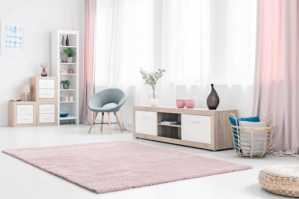 Luxurious soft pastel sheer curtains for pink walls in a modern cozy Dubai living room 2025.