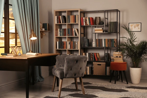 Stylish study room with falling blue curtains, wooden desk, bookshelves, and elegant modern décor in Dubai 2025.