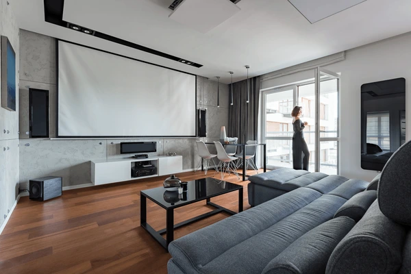 Luxurious grey curtains in a modern Dubai home theater living room with sleek furniture and cozy ambiance, stylish must-have curtains 2025.