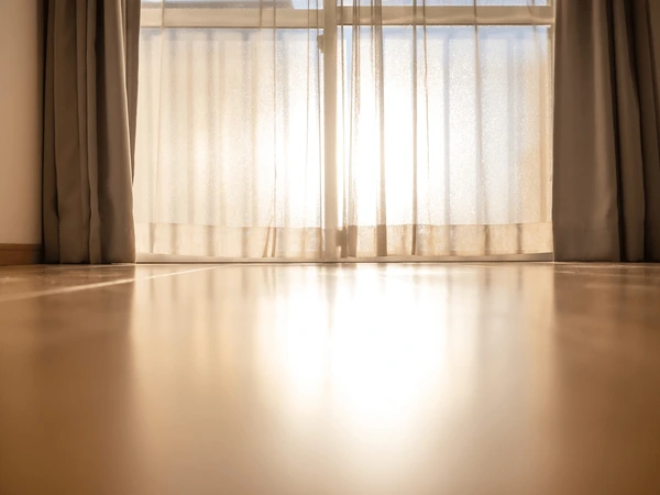 Elegant sheer beige curtains with sunlight streaming through a modern window, highlighting the best stylish and cozy curtain trends in Dubai 2025.