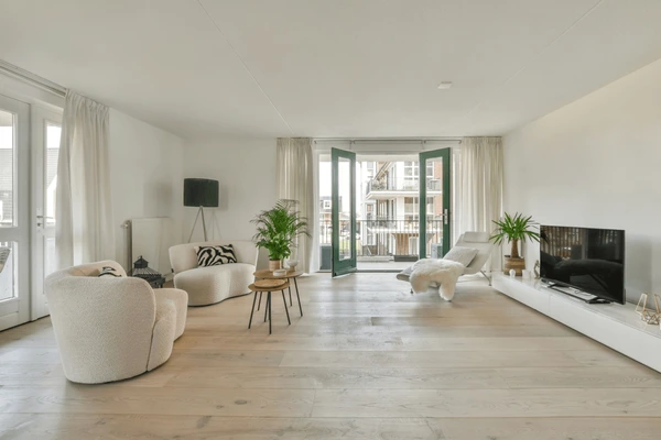 Modern minimalist living room in Dubai featuring soft sheer traditional curtains, cozy white furniture, and natural wooden flooring for a bright and elegant 2025 look.